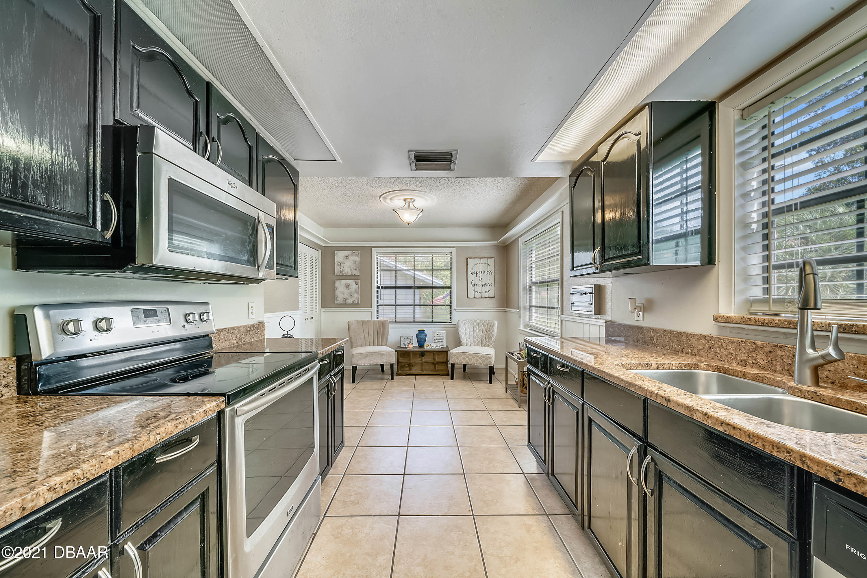 2815 Concord Road DeLand, FL 32720 - Photo 11 of 29 a kitchen with stainless steel appliances granite countertop a sink stove and cabinets
