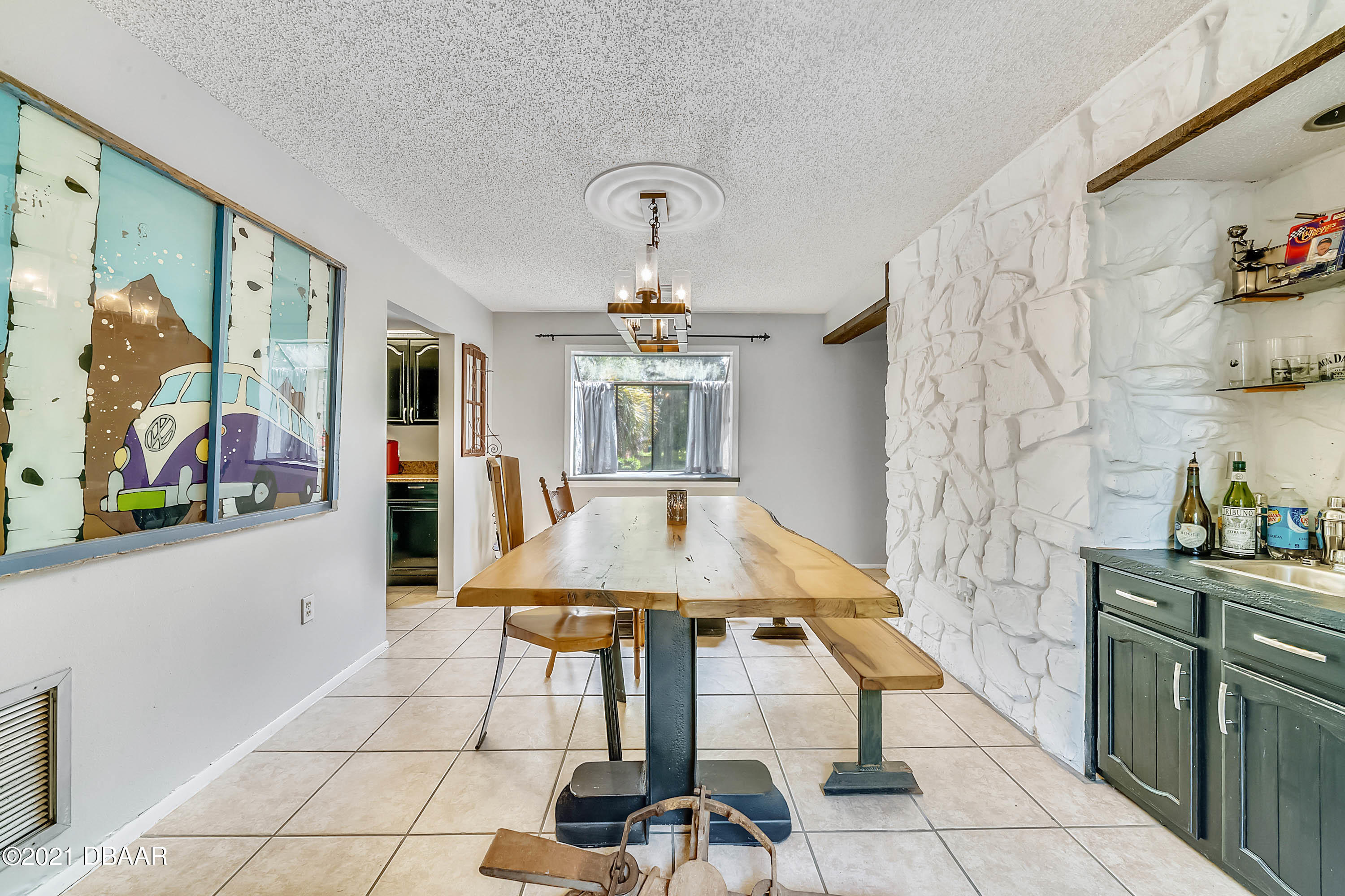 2815 Concord Road DeLand, FL 32720 - Photo 15 of 29 a hallway with a stove a dining table and chairs
