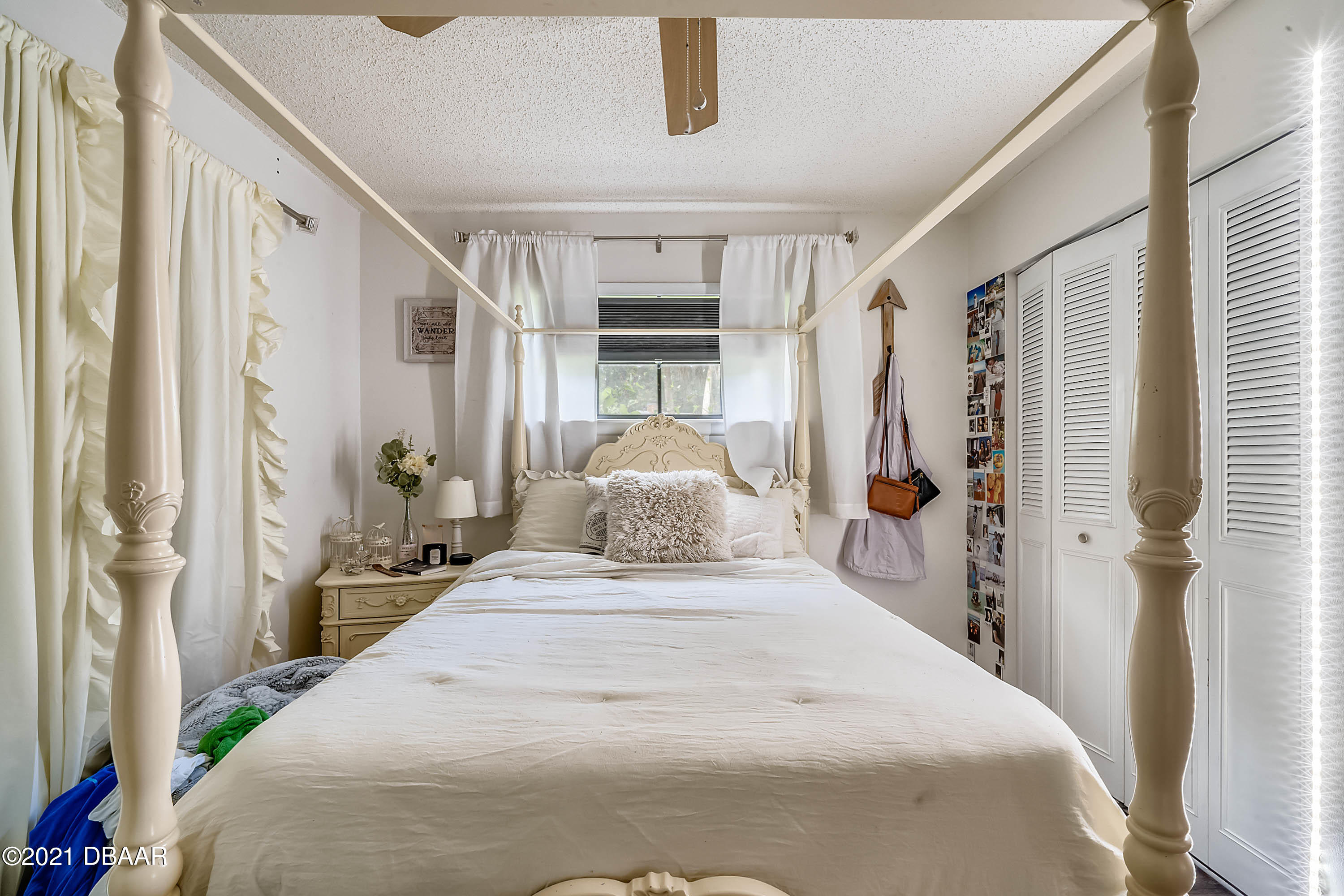 2815 Concord Road DeLand, FL 32720 - Photo 19 of 29 a bedroom with a large bed and a chandelier