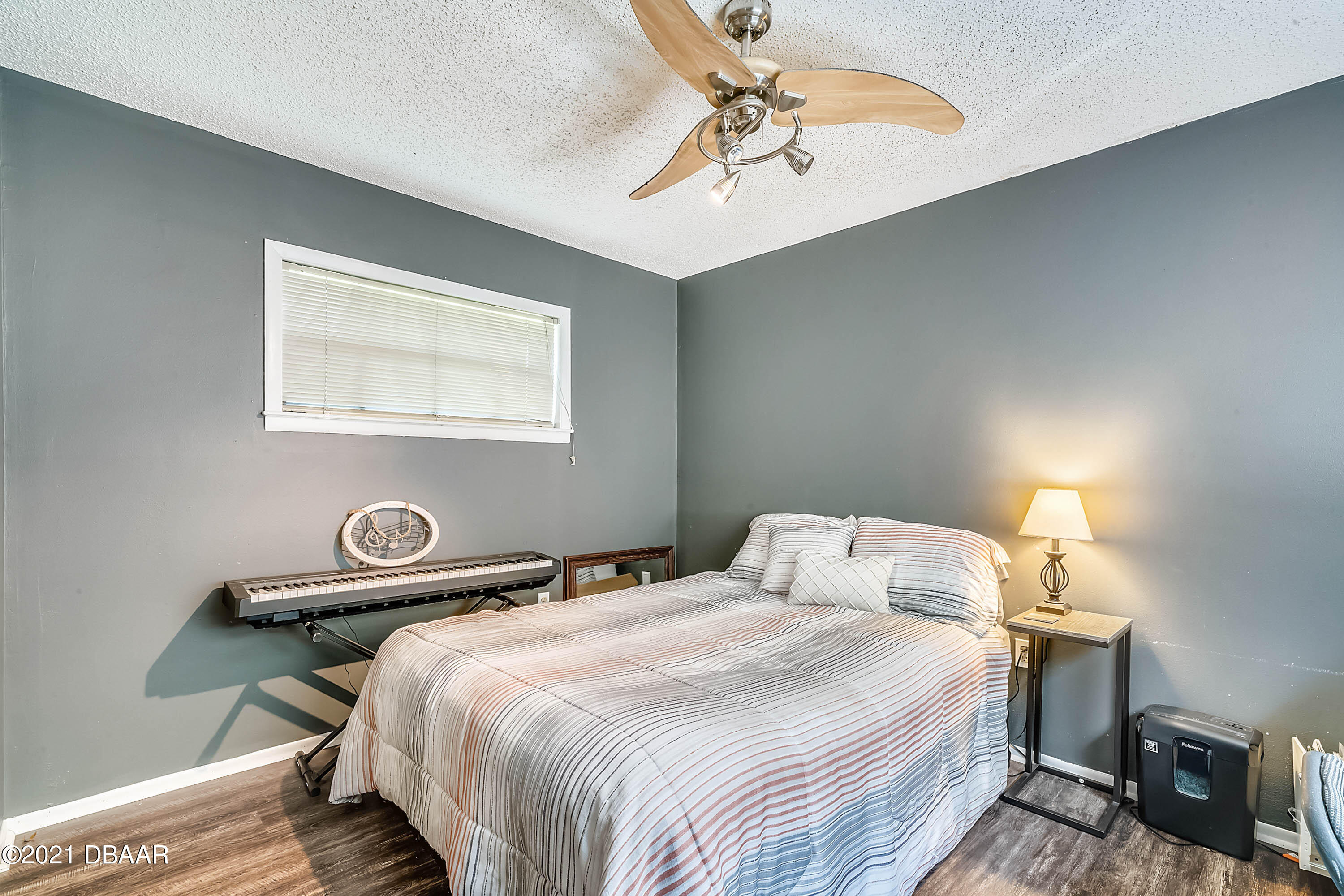 2815 Concord Road DeLand, FL 32720 - Photo 21 of 29 a bedroom with a bed and a chandelier