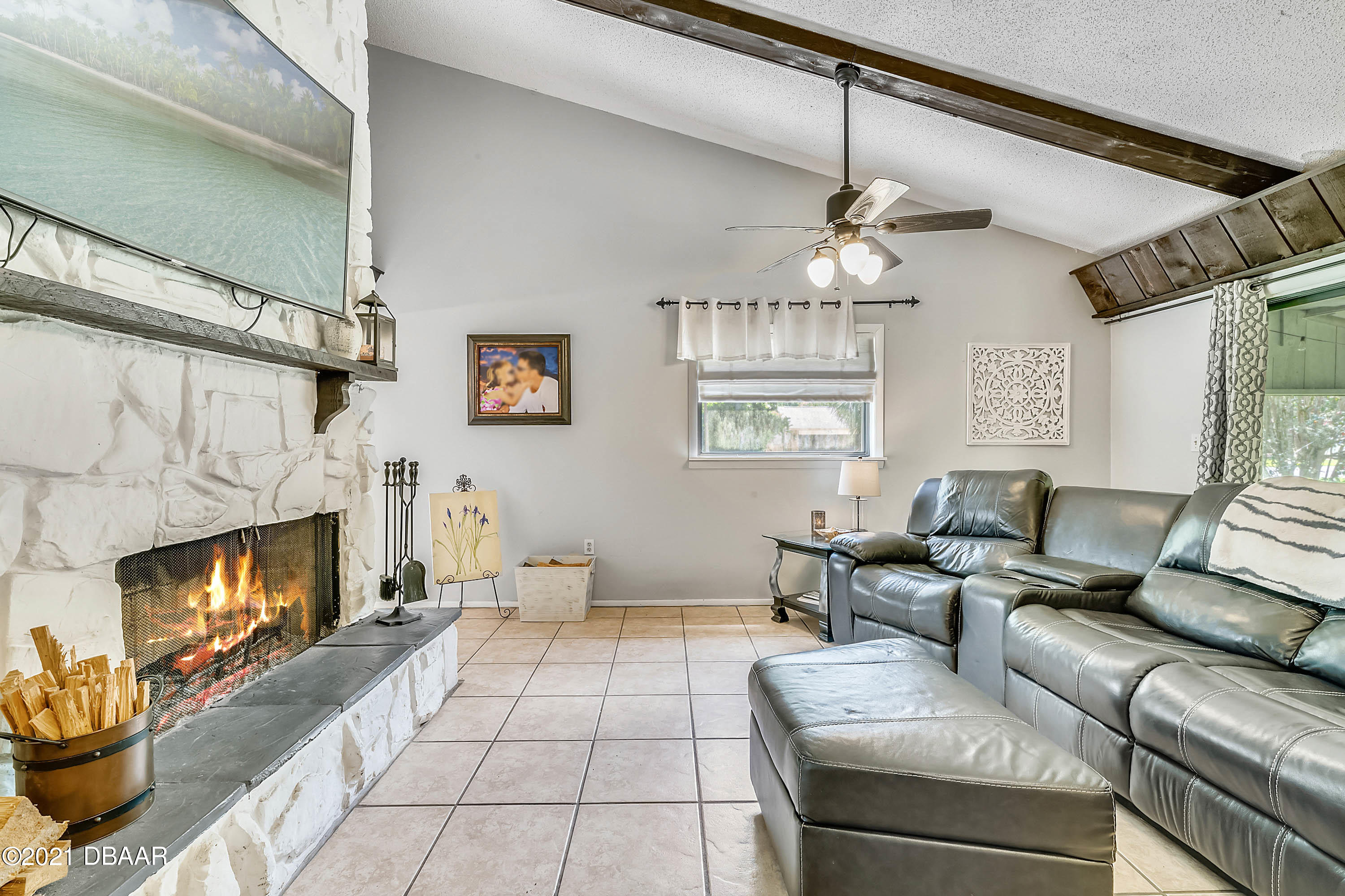 2815 Concord Road DeLand, FL 32720 - Photo 6 of 29 a living room with furniture a fireplace and a flat screen tv
