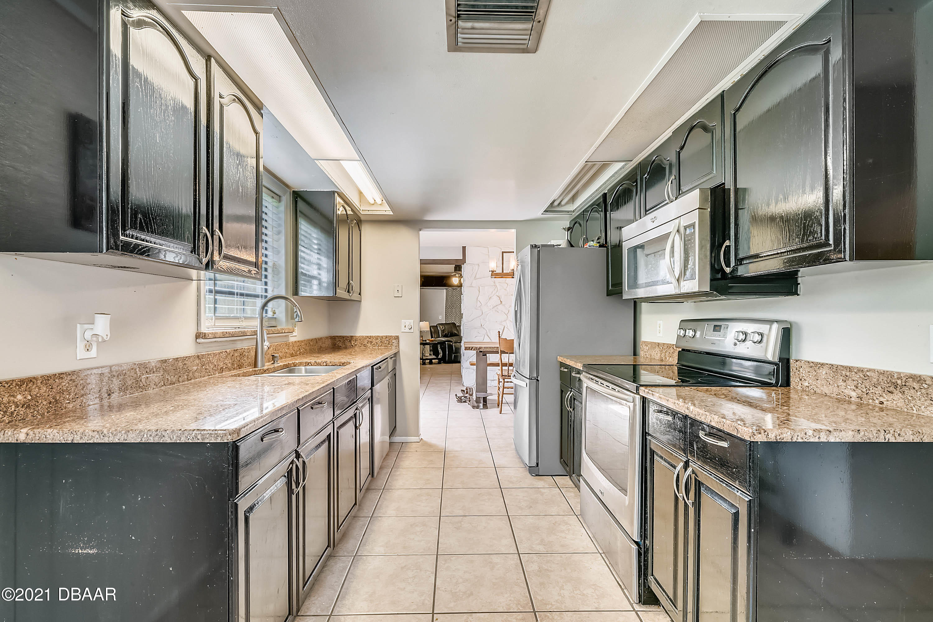 2815 Concord Road DeLand, FL 32720 - Photo 10 of 29 a kitchen with stainless steel appliances granite countertop a sink stove and refrigerator