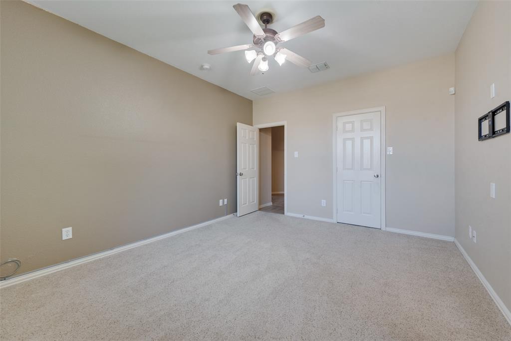 4512 Shade Tree Court Sachse, TX 75048 - Photo 11 of 19 a view of an empty room with a ceiling fan