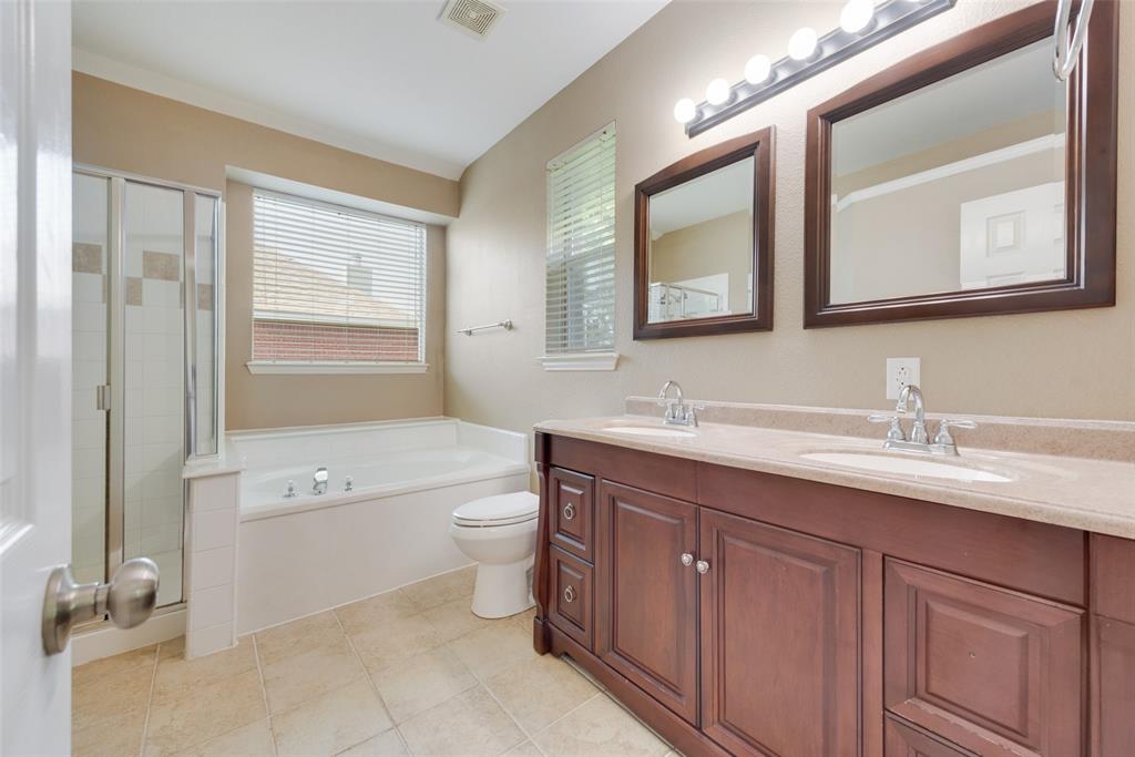 4512 Shade Tree Court Sachse, TX 75048 - Photo 12 of 19 a bathroom with a toilet a sink a tub and mirror