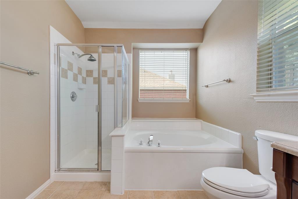 4512 Shade Tree Court Sachse, TX 75048 - Photo 13 of 19 a bathroom with a bathtub toilet and shower