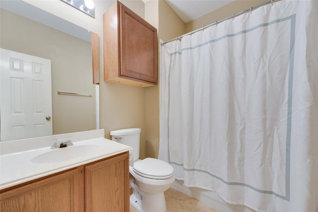 4512 Shade Tree Court Sachse, TX 75048 - Photo 14 of 19 a bathroom with a sink a toilet and shower