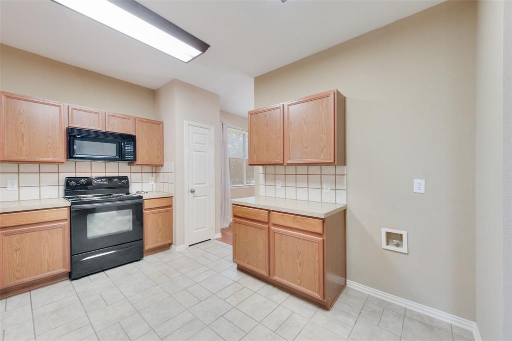 4512 Shade Tree Court Sachse, TX 75048 - Photo 6 of 19 a kitchen with stainless steel appliances granite countertop a stove top oven a sink and dishwasher