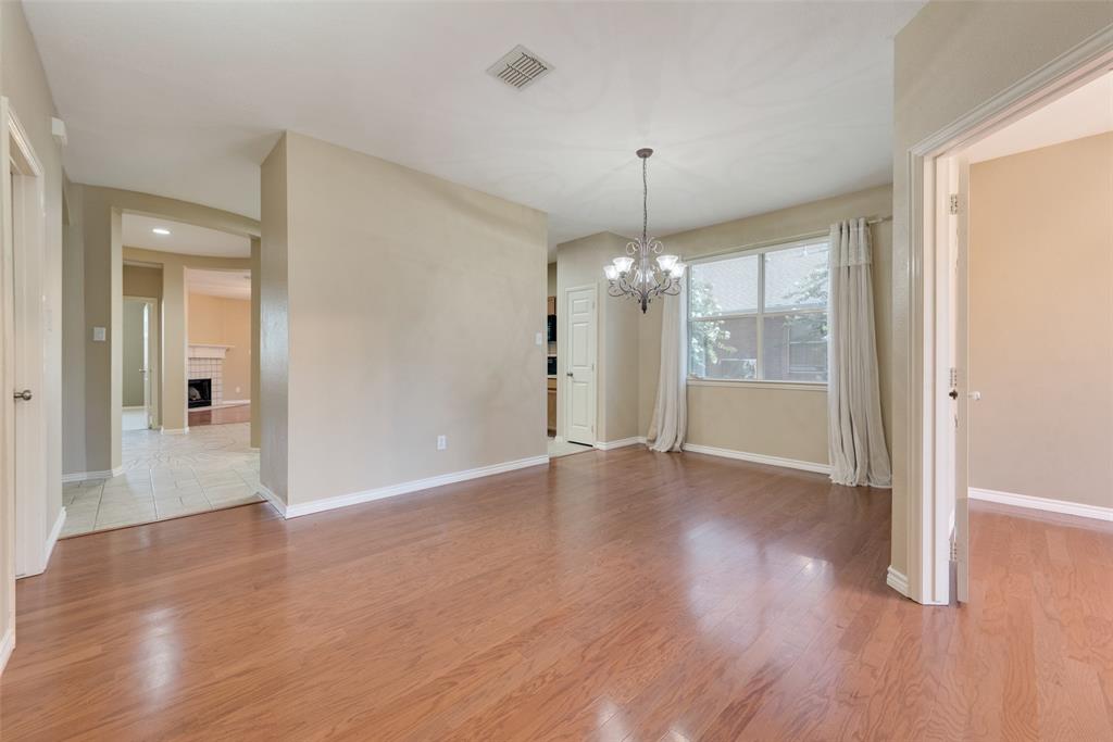 4512 Shade Tree Court Sachse, TX 75048 - Photo 8 of 19 a view of a room with wooden floor a ceiling fan and window