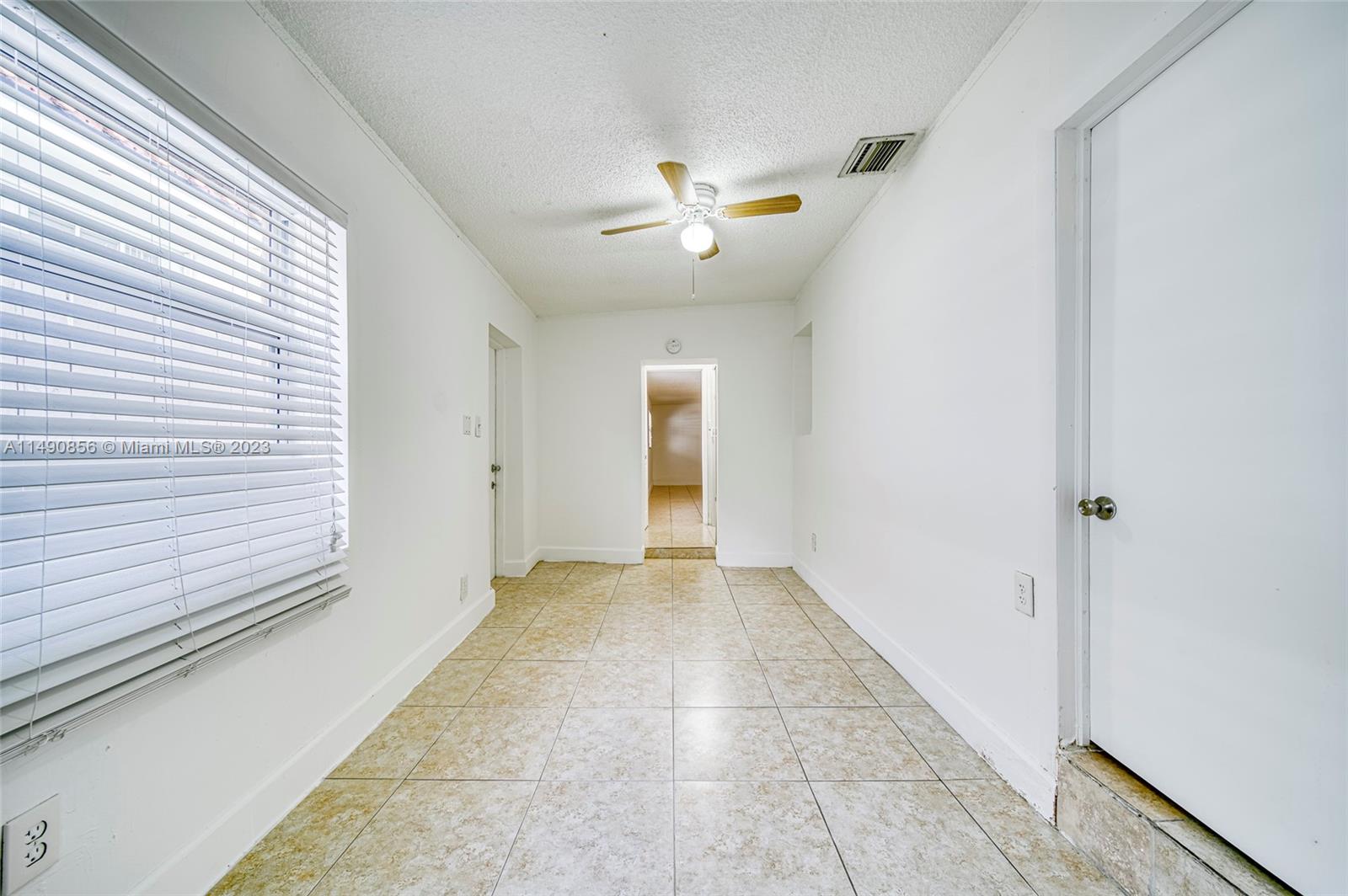 6534 Southwest 34th Street, Unit 2 Miami, FL 33155 - Photo 13 of 20 a view of a livingroom with a ceiling fan and window