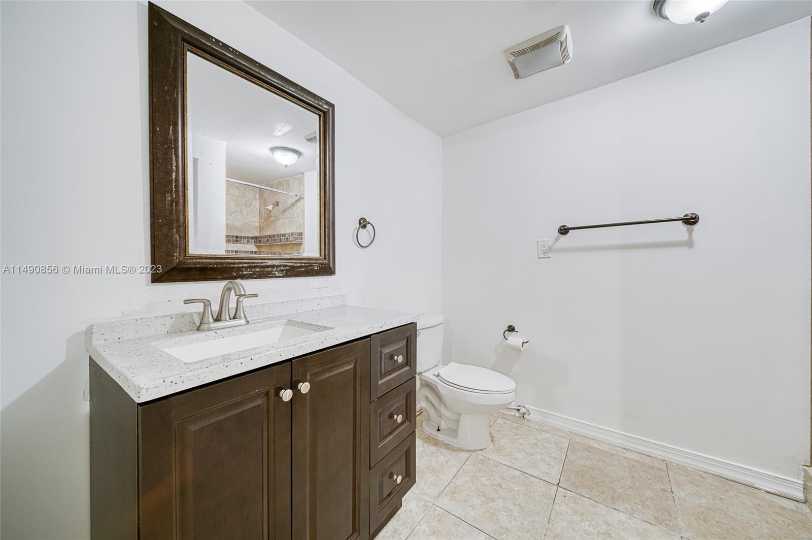 6534 Southwest 34th Street, Unit 2 Miami, FL 33155 - Photo 16 of 20 a bathroom with a toilet sink and mirror