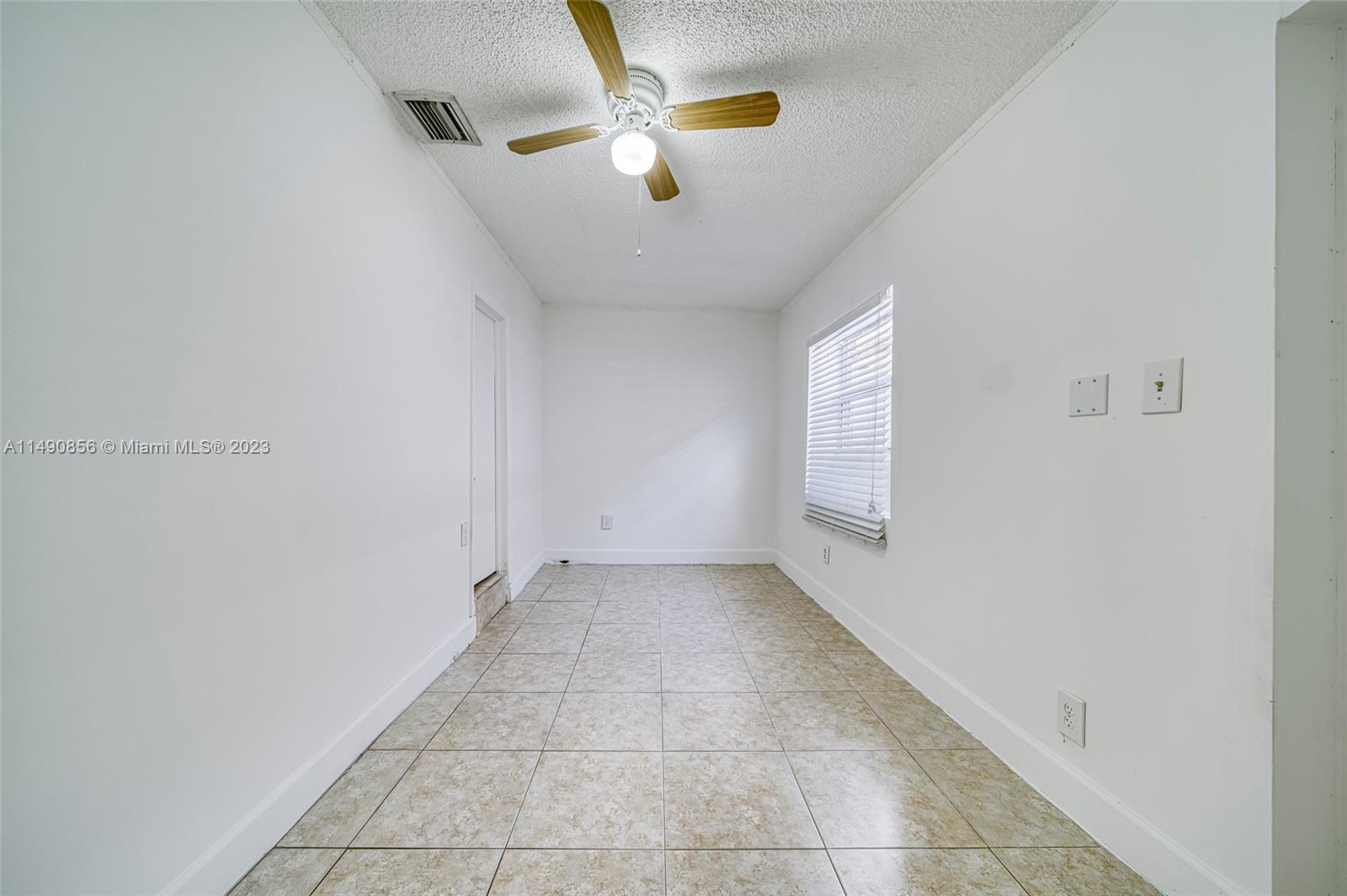 6534 Southwest 34th Street, Unit 2 Miami, FL 33155 - Photo 18 of 20 an empty room with ceiling fan and window