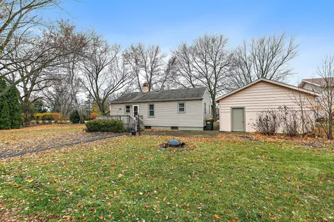 a view of a yard with a house and a tree