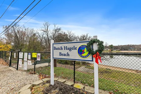 a kitchen with white cabinets and wooden floor
