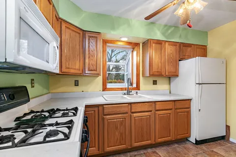 a view of a room with wooden floor and windows