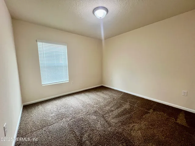 an empty room with a empty space and a window