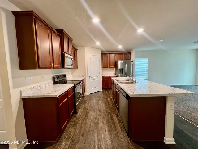 a kitchen with counter top space sink and center island