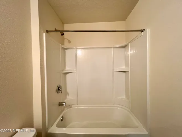 a bathroom with a shower and a bath tub
