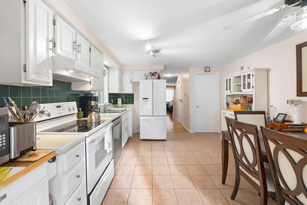150 Webster Avenue, Unit 3 Chelsea, MA 02150 - Photo 6 of 36 a kitchen with stainless steel appliances kitchen island granite countertop a sink and cabinets