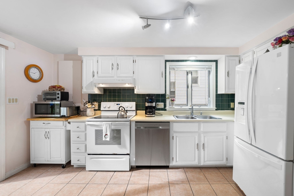 150 Webster Avenue, Unit 3 Chelsea, MA 02150 - Photo 7 of 36 a kitchen with cabinets and appliances