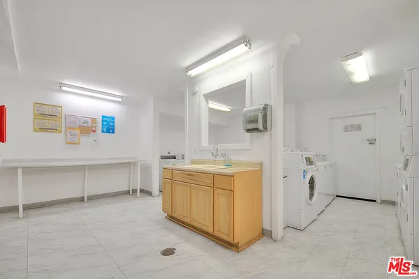 a spacious bathroom with a double vanity sink and a mirror
