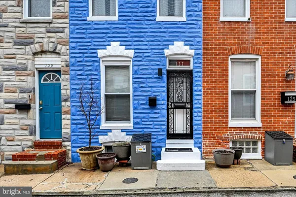 a brick building with a bench in front of it
