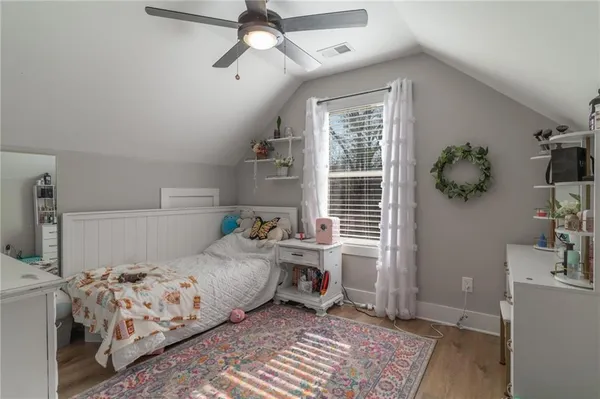 a view of a backyard with plants and wooden stairs