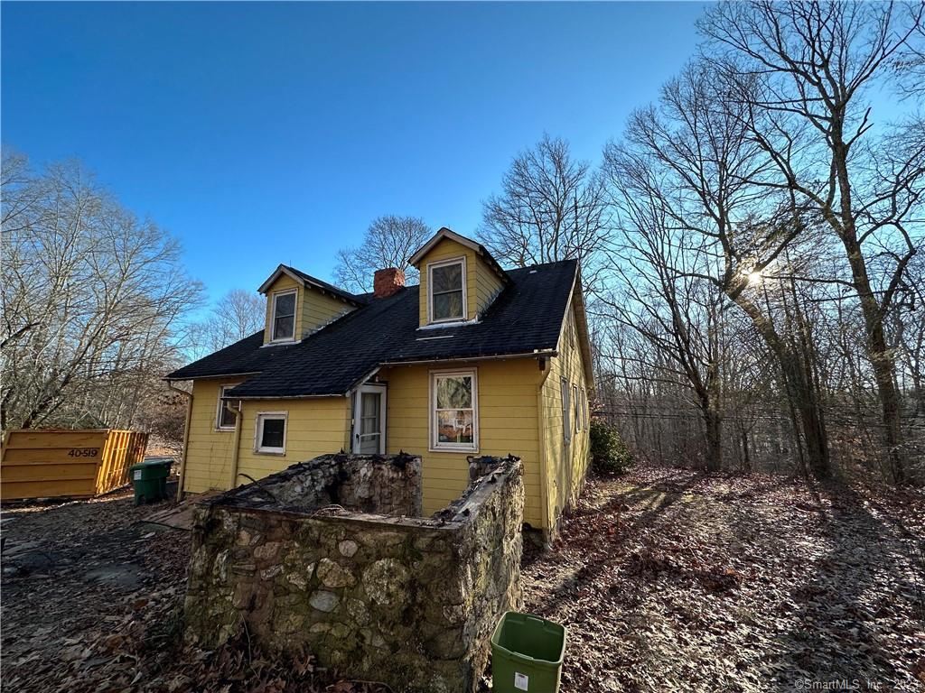 107 Old Toll Road Madison, CT 06443 - Photo 1 of 1 a front view of house with yard and trees in the background