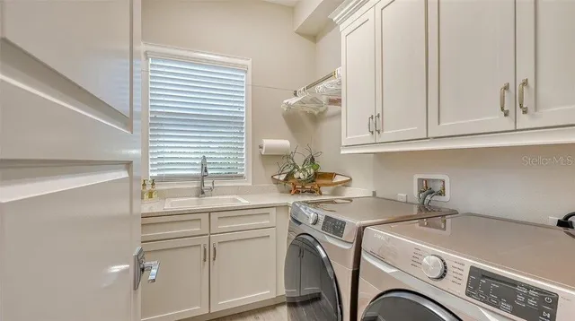 a view of a kitchen with sink dryer and washer