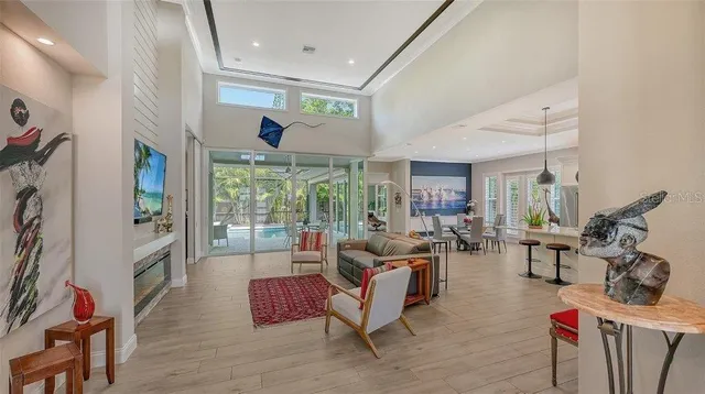 a living room with furniture large window and flat screen tv