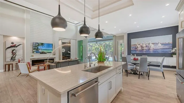 a kitchen with stainless steel appliances granite countertop a stove and a wooden floors