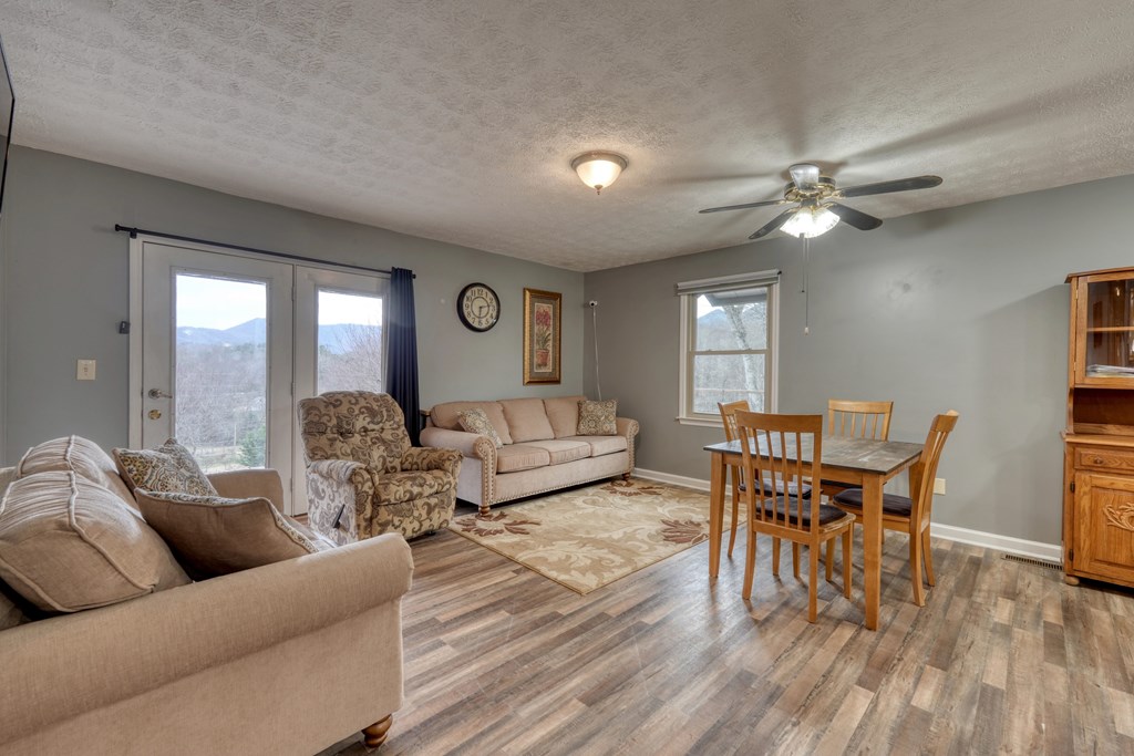 2276 Lovingood Road Hiawassee, GA 30546 - Photo 11 of 54 a living room with furniture and wooden floor