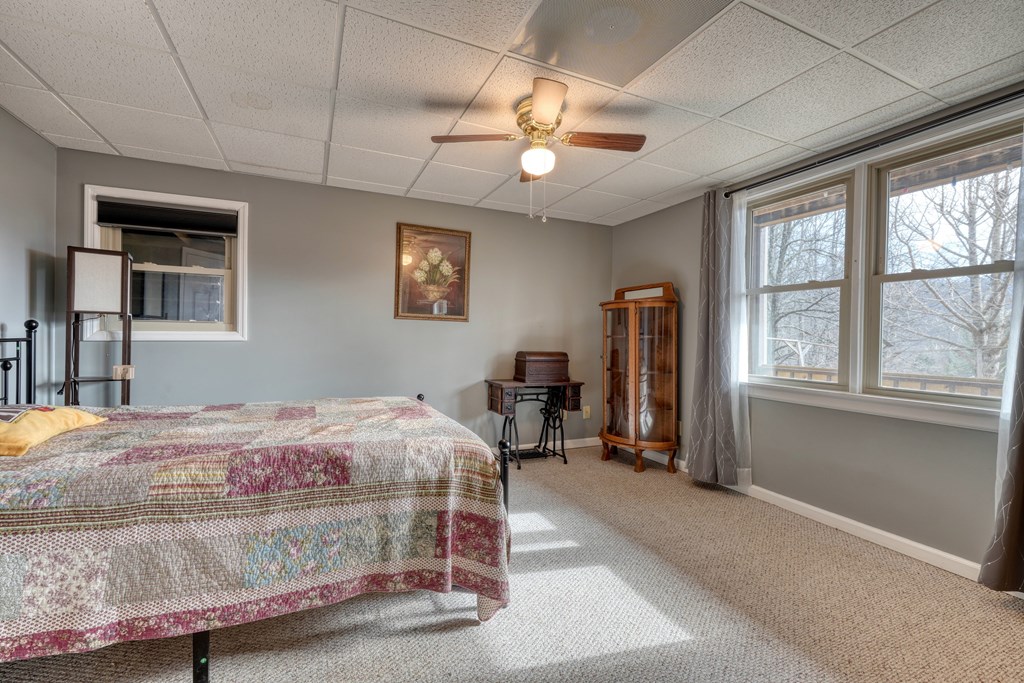 2276 Lovingood Road Hiawassee, GA 30546 - Photo 26 of 54 a bedroom with a bed couch and a window