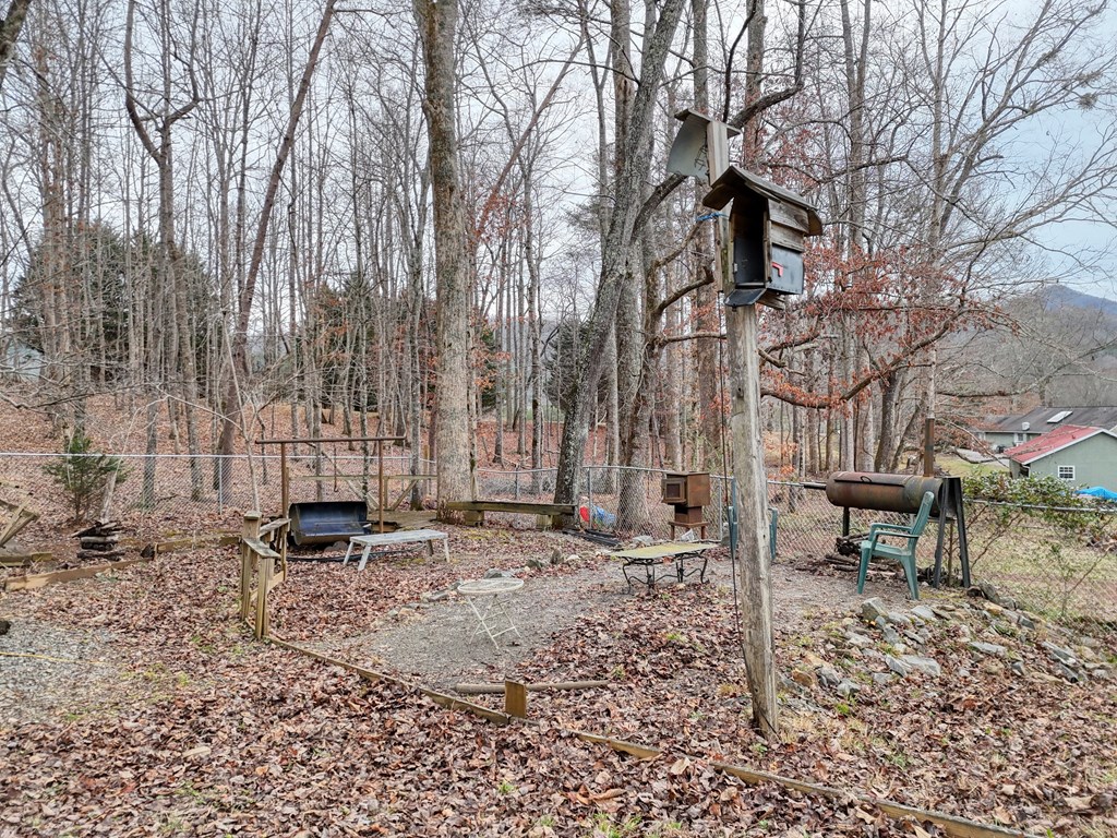 2276 Lovingood Road Hiawassee, GA 30546 - Photo 46 of 54 a backyard of a house with table and chairs