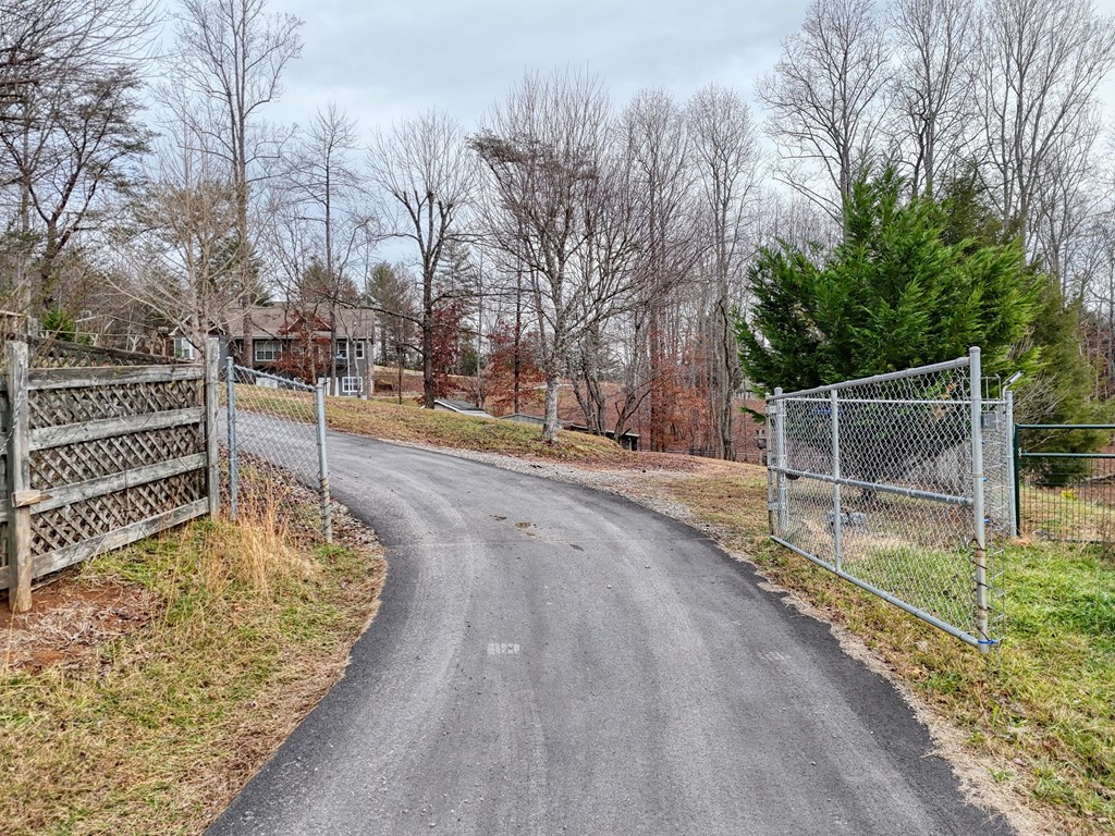 2276 Lovingood Road Hiawassee, GA 30546 - Photo 48 of 54 a backyard with wooden fence and large trees