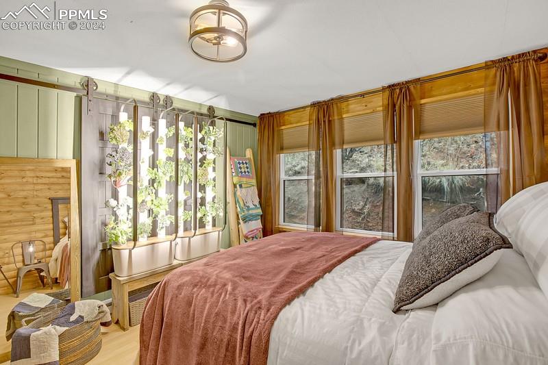 361 Willow Road Divide, CO 80814 - Photo 18 of 28 a bedroom with a large bed and a large window