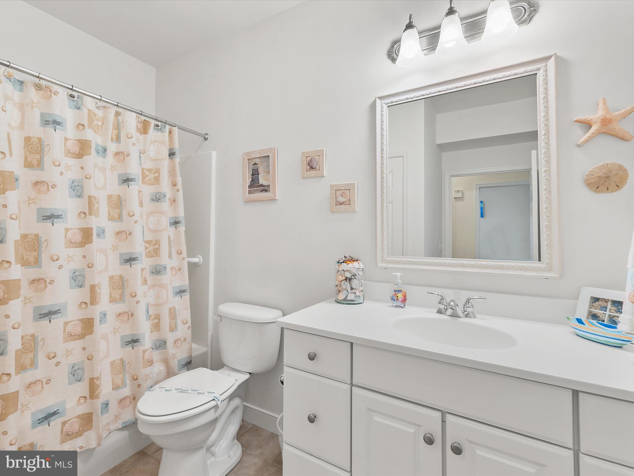 30611 Cedar Neck Road, Unit 2204 Ocean View, DE 19970 - Photo 14 of 33 a bathroom with a sink toilet and shower