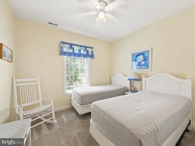 a bedroom with two beds and a window