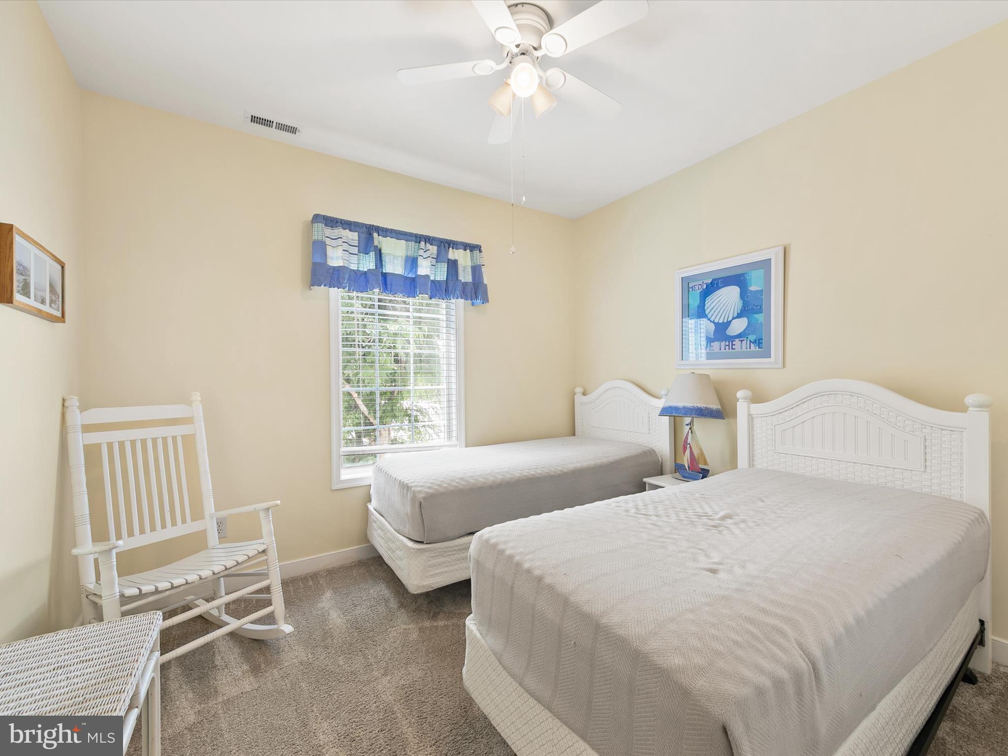 30611 Cedar Neck Road, Unit 2204 Ocean View, DE 19970 - Photo 20 of 33 a bedroom with two beds and a window