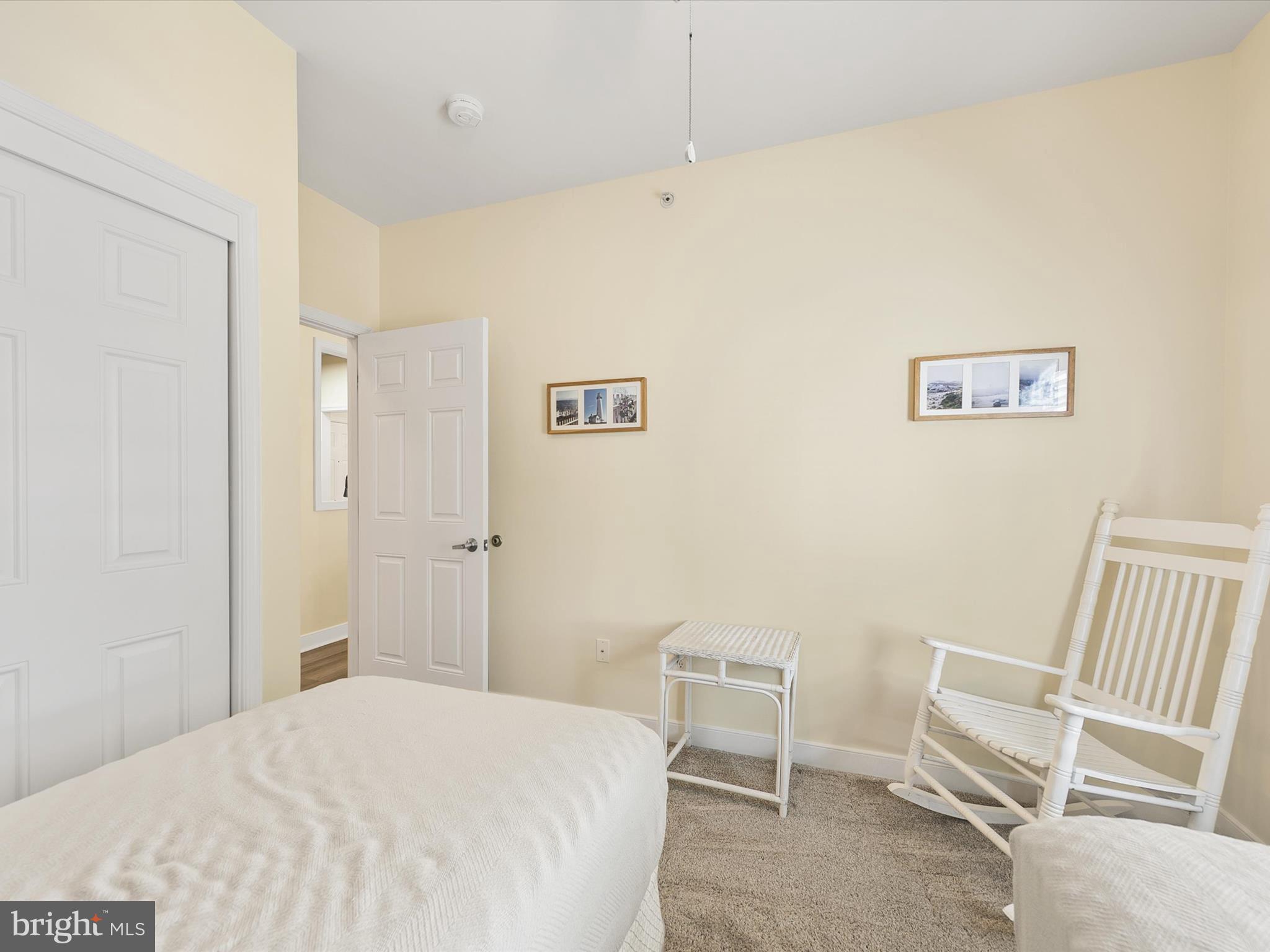 30611 Cedar Neck Road, Unit 2204 Ocean View, DE 19970 - Photo 21 of 33 a bedroom with a bed and chair