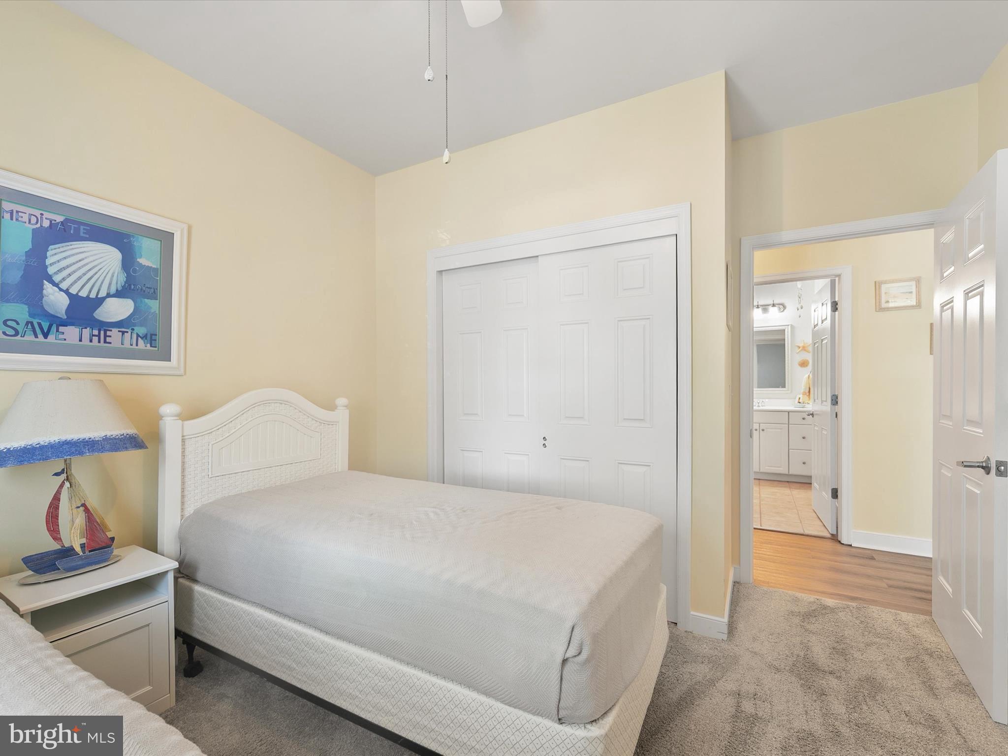 30611 Cedar Neck Road, Unit 2204 Ocean View, DE 19970 - Photo 22 of 33 a bedroom with a bed and a painting on the wall