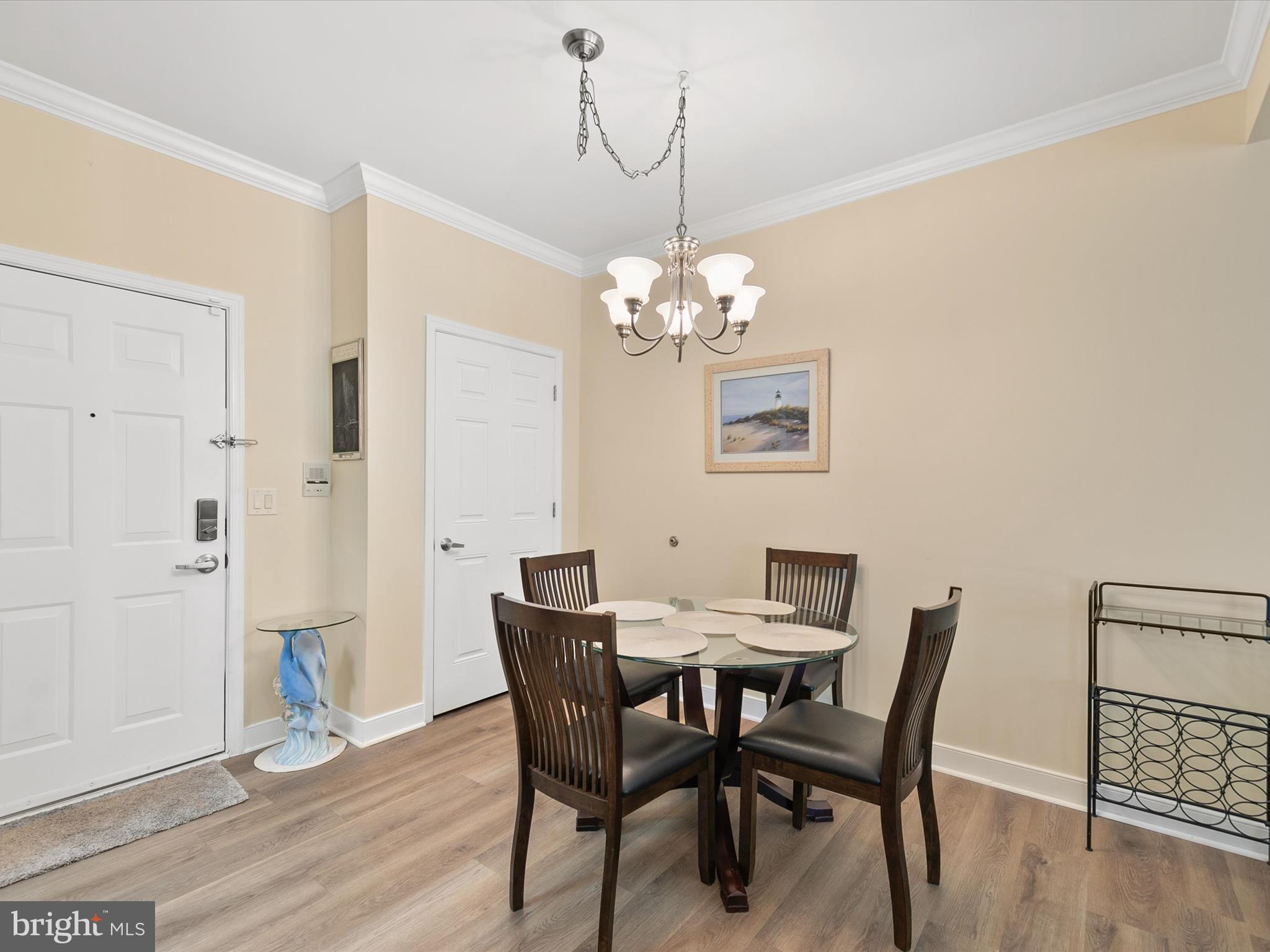 30611 Cedar Neck Road, Unit 2204 Ocean View, DE 19970 - Photo 8 of 33 a view of a dining room with furniture and wooden floor