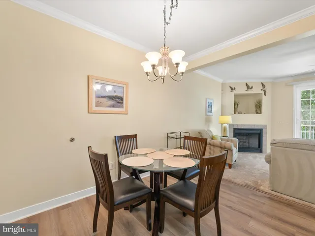 a view of a dining room with furniture wooden floor and chandelier