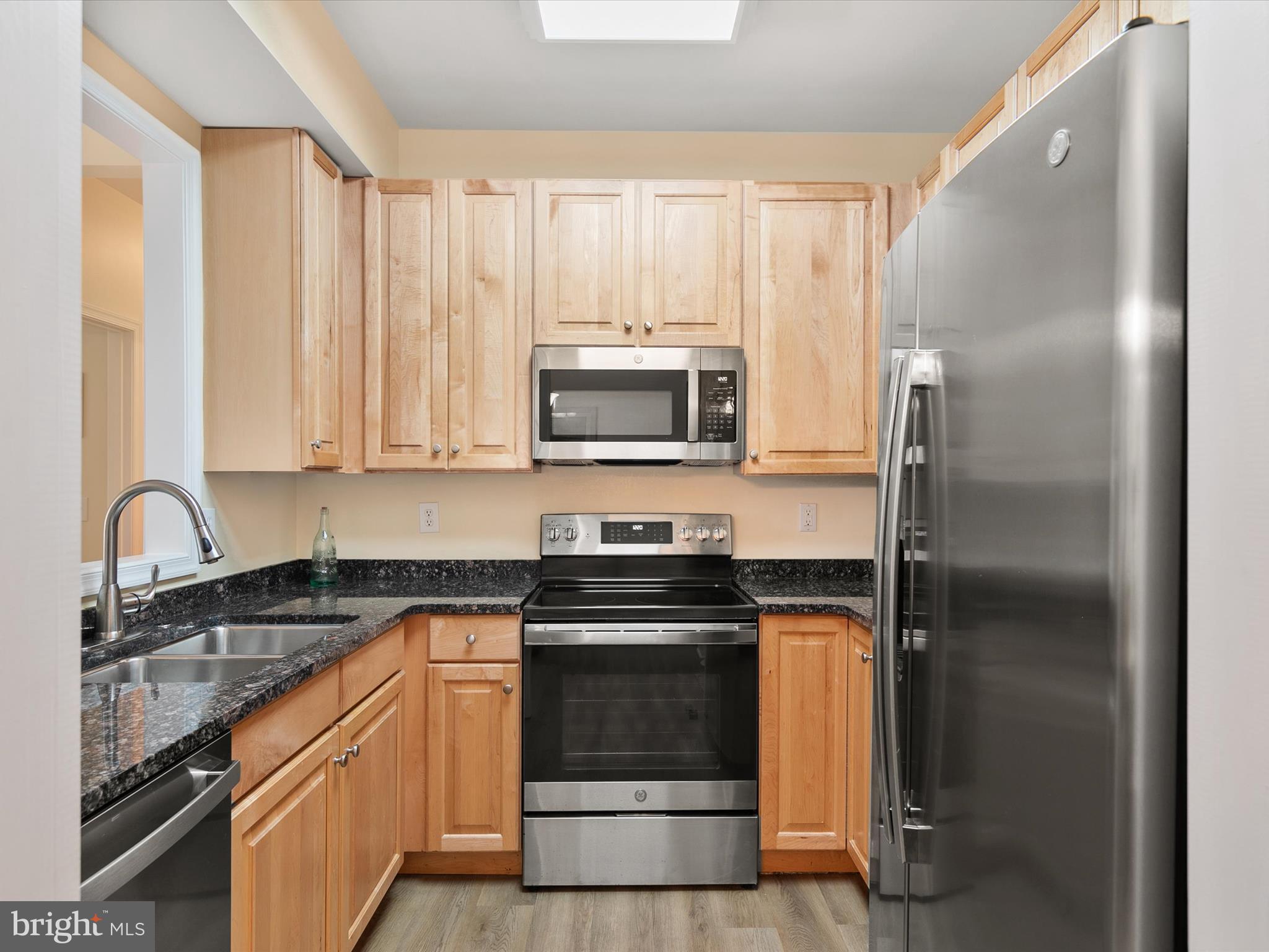 30611 Cedar Neck Road, Unit 2204 Ocean View, DE 19970 - Photo 10 of 33 a kitchen with stainless steel appliances granite countertop a stove a refrigerator and a sink