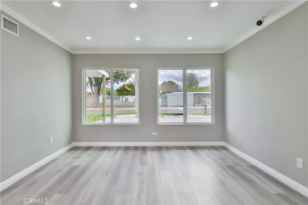 a view of room with window and wooden floor