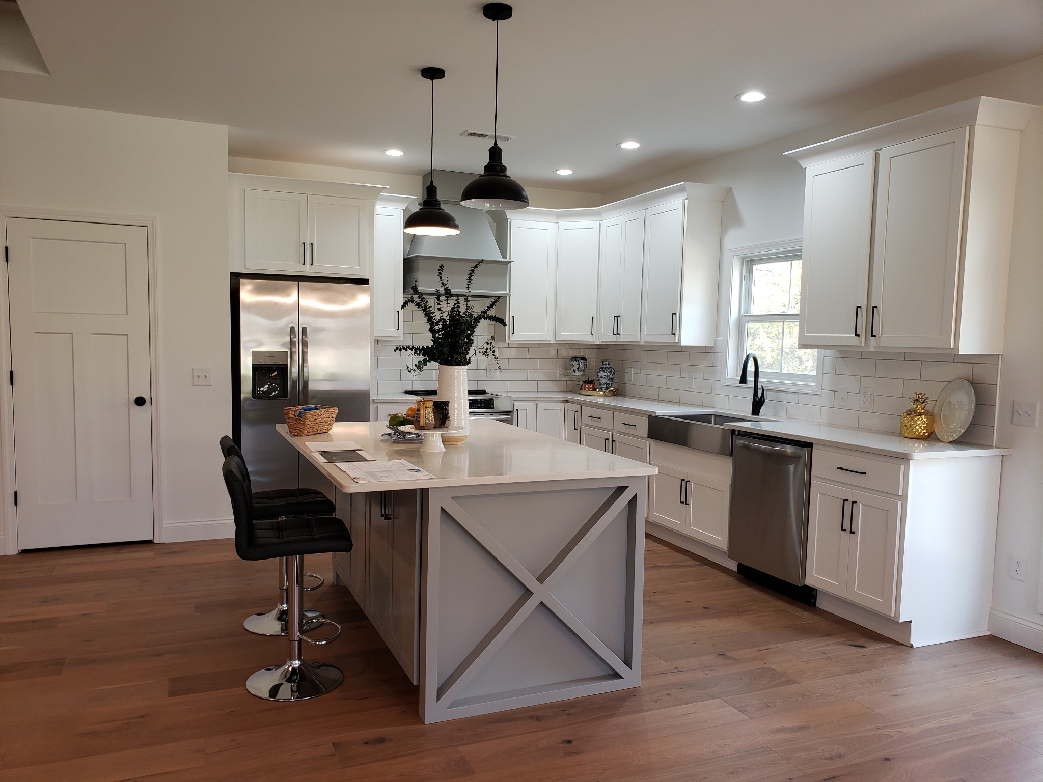 8221 Cookeville Boatdock Road Baxter, TN 38544 - Photo 8 of 13 a kitchen with a sink a center island cabinets and stainless steel appliances