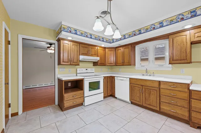 a kitchen with stainless steel appliances granite countertop a stove and a sink
