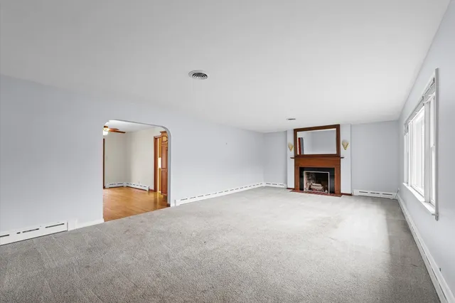 a view of an empty room with a fireplace