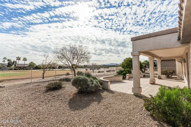 a view of a backyard with sitting area