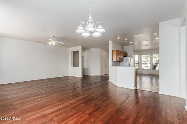 a view of a kitchen with granite countertop wooden floor and a refrigerator