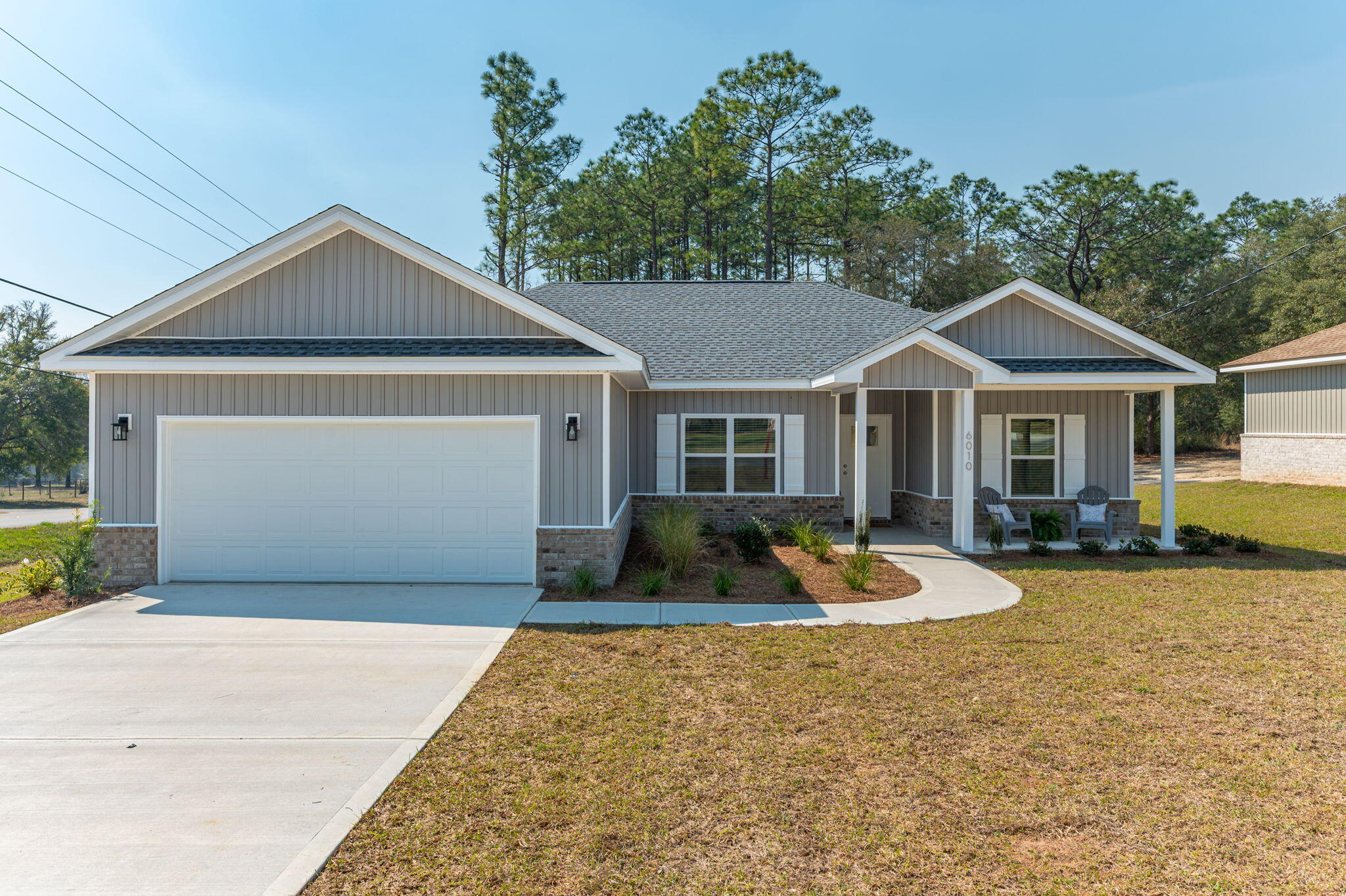 6010 Sand Hill Road Crestview, FL 32539 - Photo 1 of 33 a front view of a house with garden